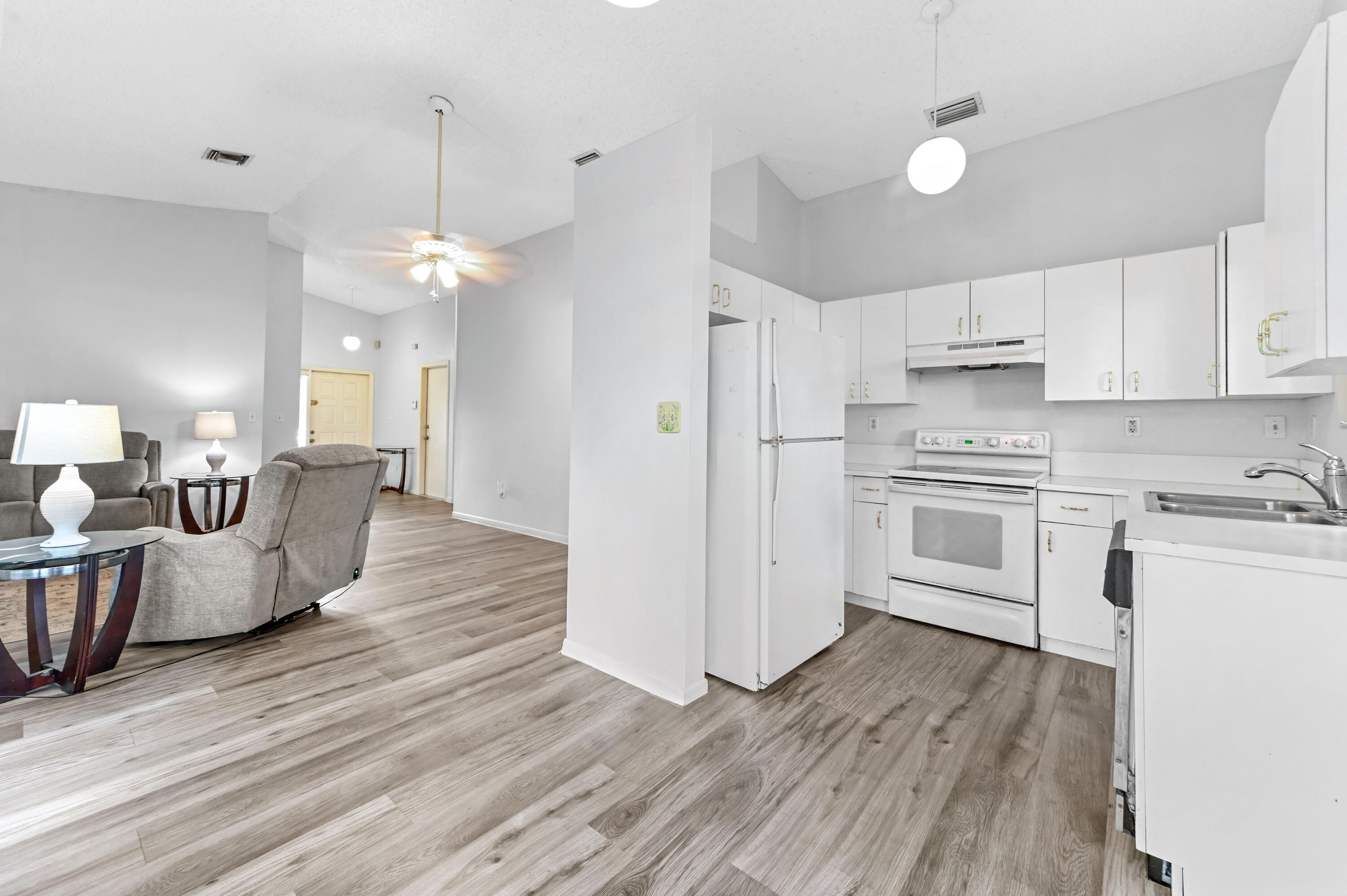 3325 Northwest 79th Way Davie, FL 33024 - Photo 9 of 29 a large kitchen with cabinets wooden floor and stainless steel appliances