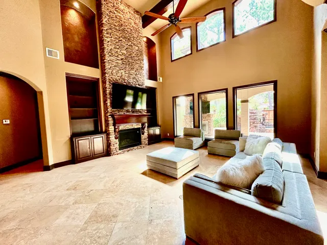 a living room with furniture fireplace and flat screen tv