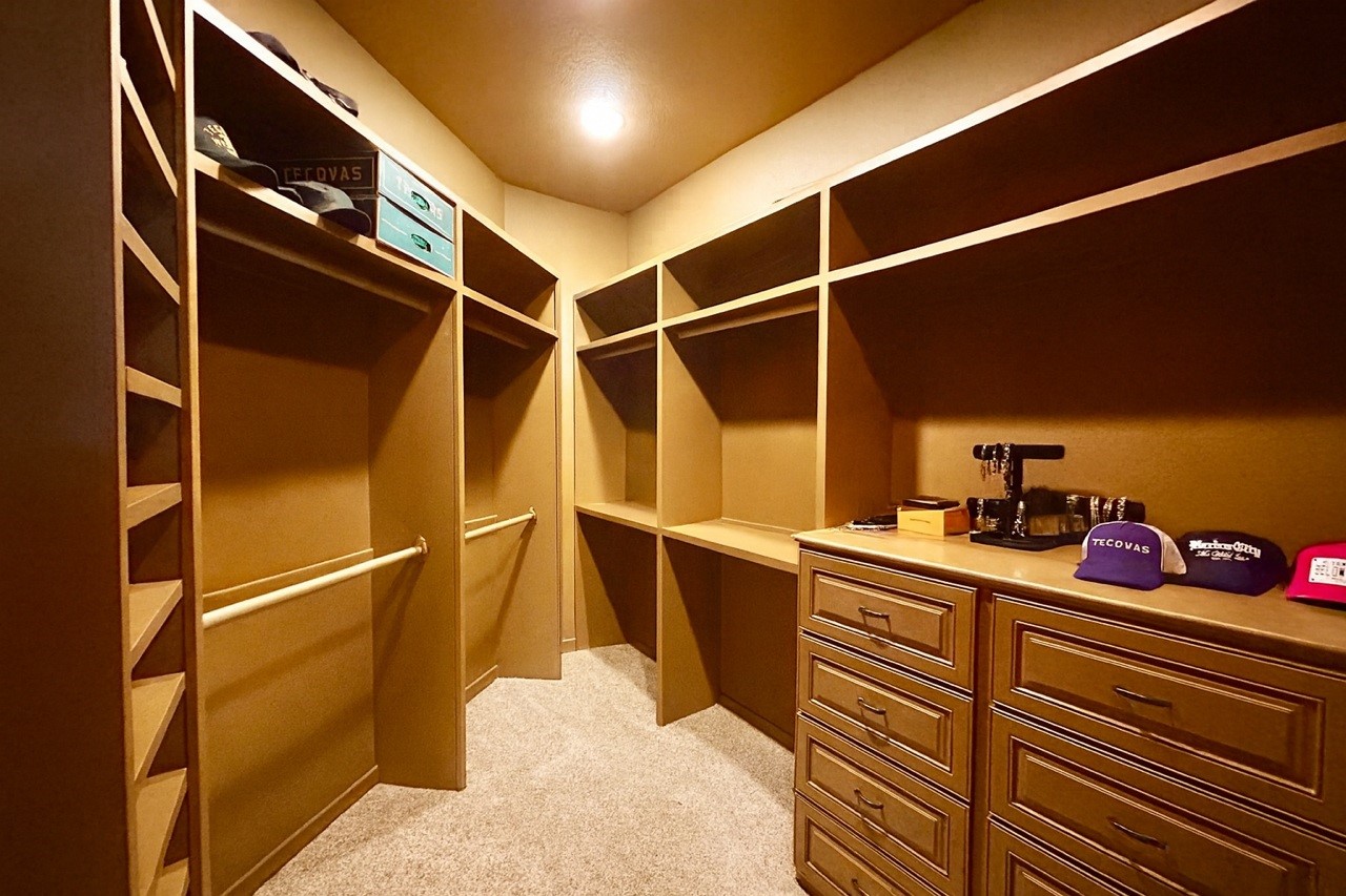7511 Raes Creek Drive Spring, TX 77389 - Photo 21 of 41 a view of walk in closet with clothes and shoes