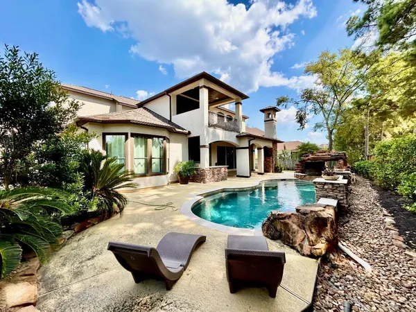 a dining hall with stainless steel appliances granite countertop a stove and a fireplace