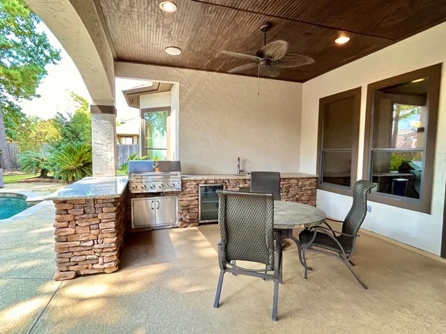 a view of a patio with table and chairs and potted plants