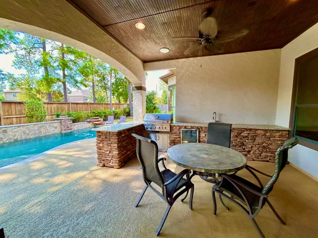 a dining hall with stainless steel appliances granite countertop a stove and a fireplace