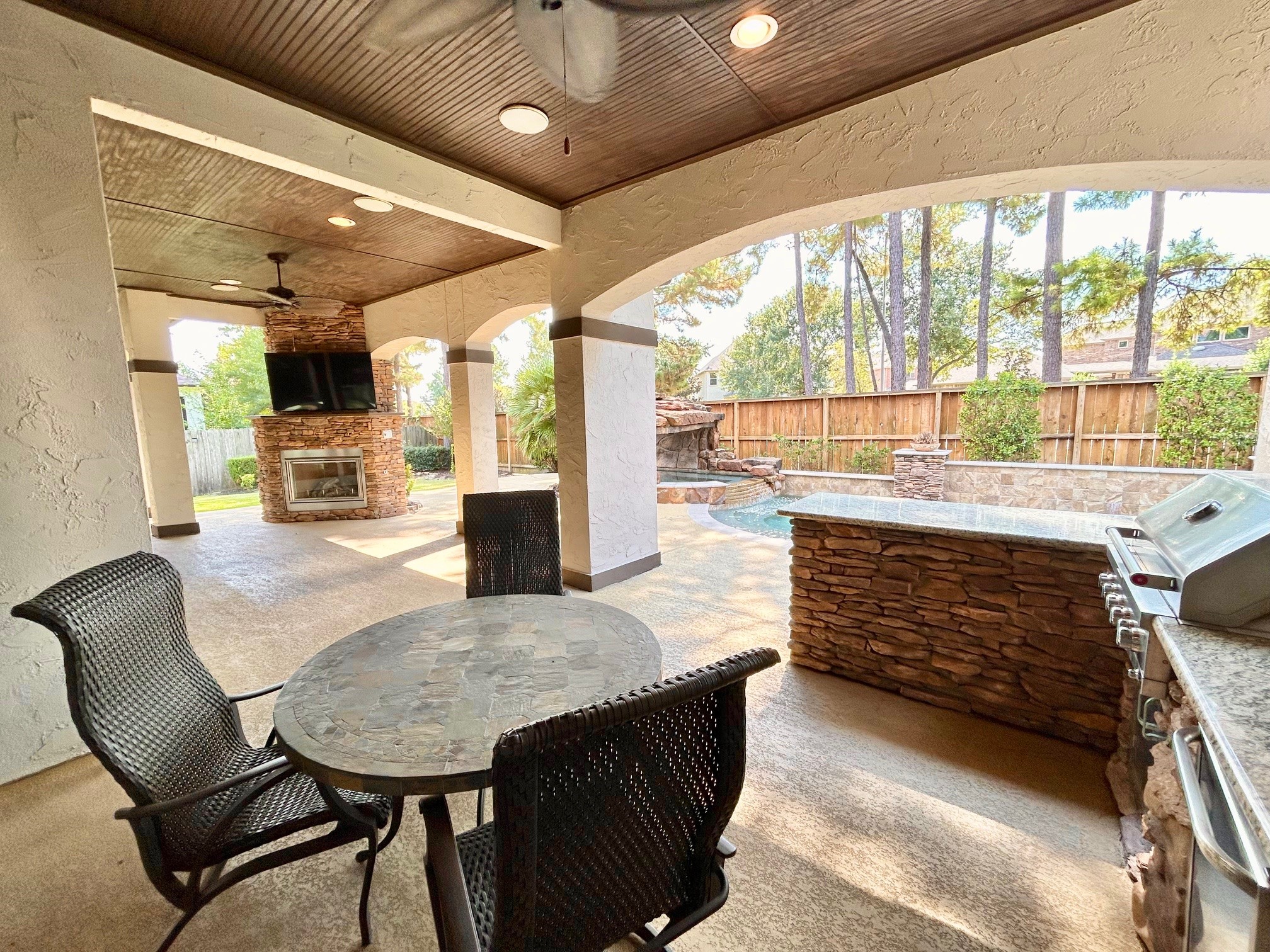 7511 Raes Creek Drive Spring, TX 77389 - Photo 30 of 41 a dining hall with stainless steel appliances granite countertop a stove and a fireplace