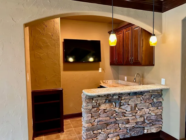 a bathroom with a granite countertop sink toilet mirror and bathtub