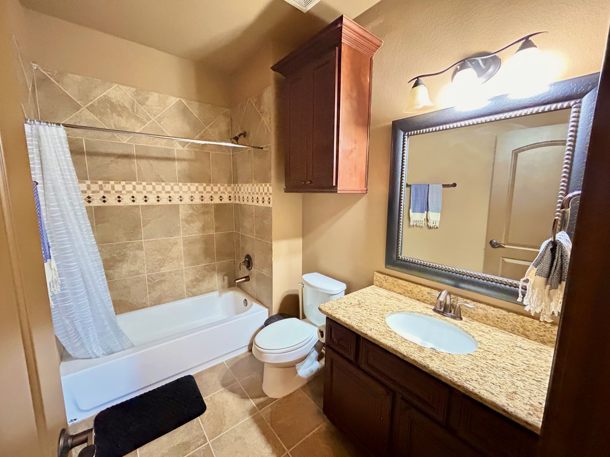 7511 Raes Creek Drive Spring, TX 77389 - Photo 33 of 41 a bathroom with a granite countertop sink toilet mirror and bathtub