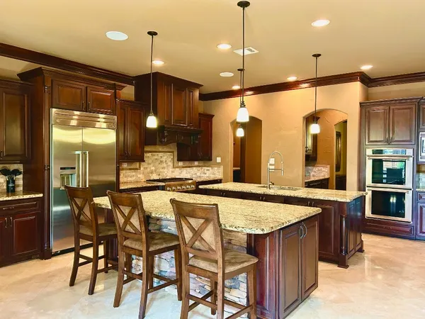 a view of a dining room with furniture and chandelier
