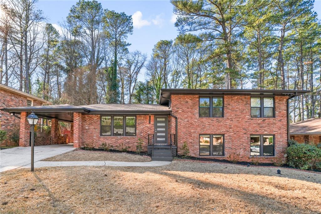 3349 Toney Drive Decatur, GA 30032 - Photo 1 of 1 a front view of a house with a yard covered in snow