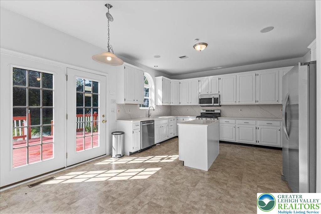 6832 Scenic View Drive Lower Macungie Township, PA 18062 - Photo 7 of 21 a kitchen with stainless steel appliances granite countertop a refrigerator sink and cabinets