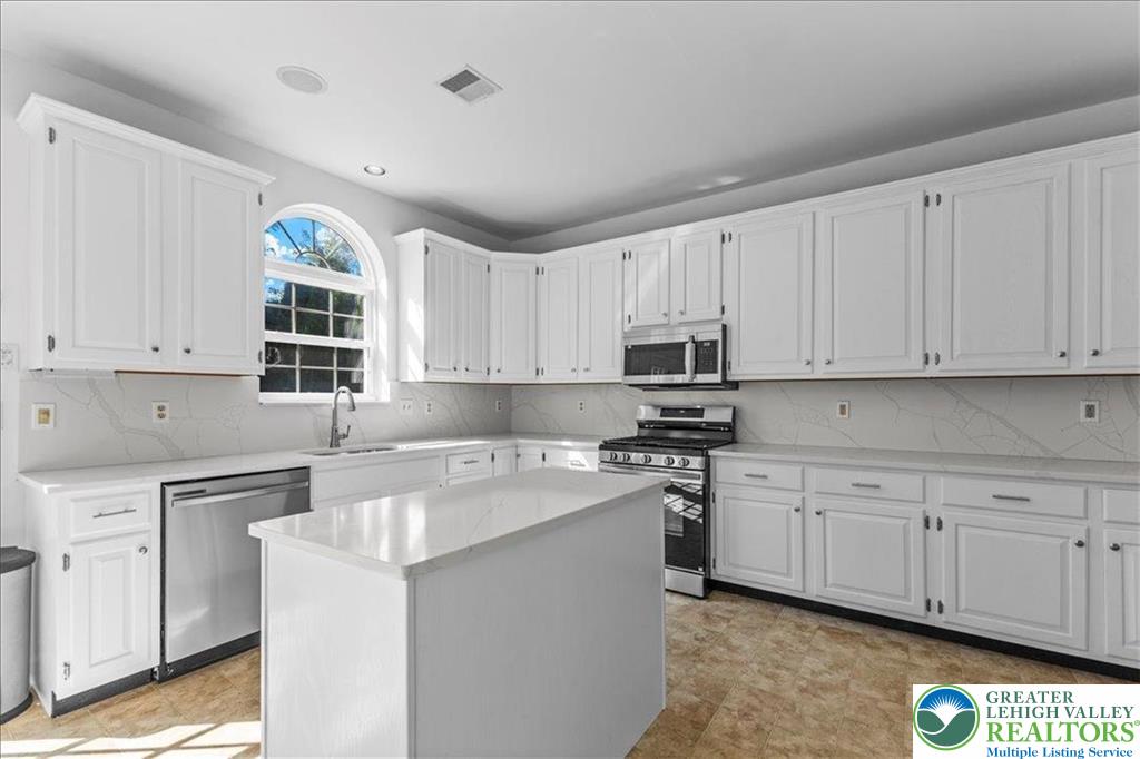 6832 Scenic View Drive Lower Macungie Township, PA 18062 - Photo 8 of 21 a kitchen with cabinets appliances a sink and a window