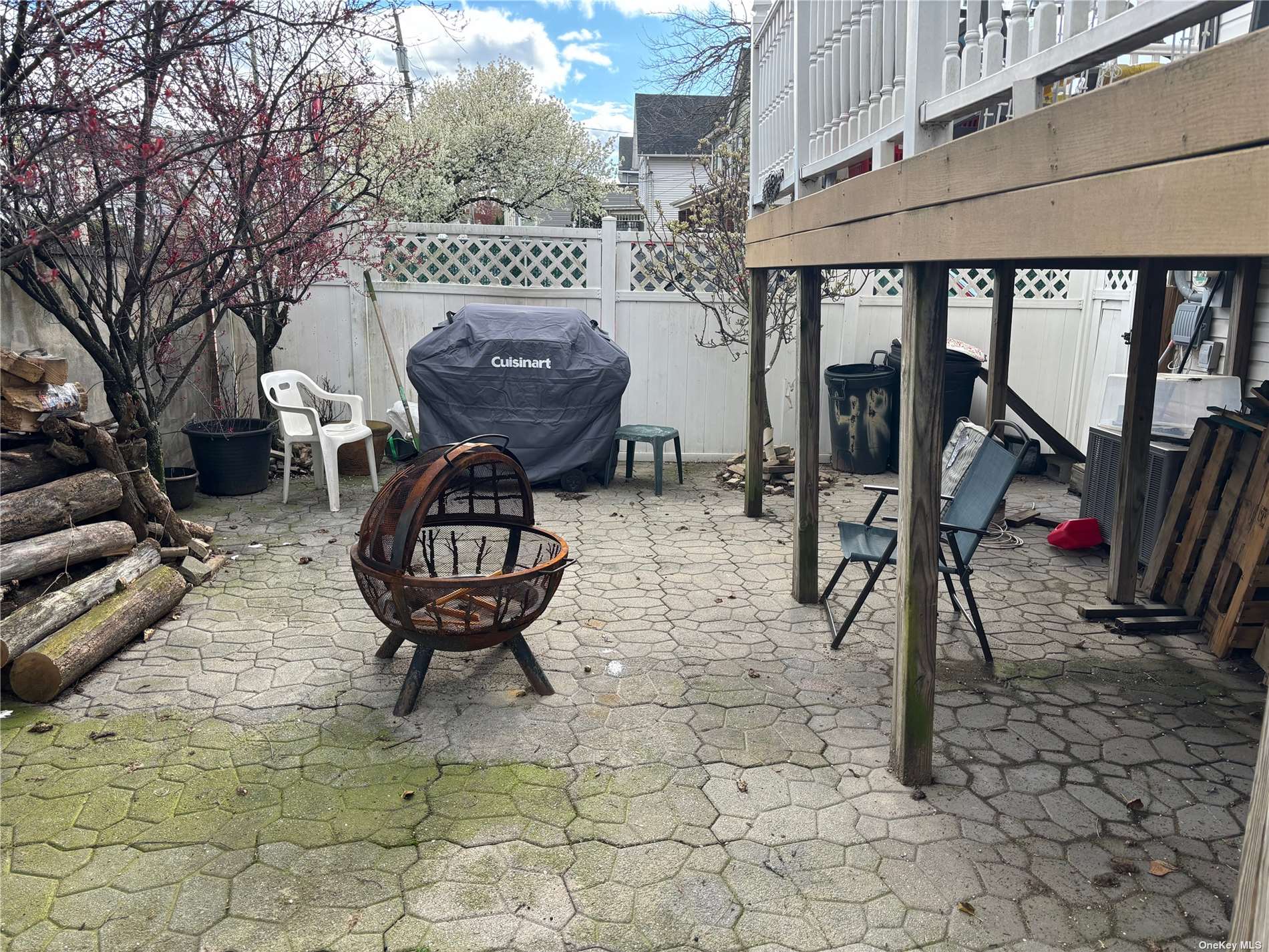 a view of a chairs and table in backyard