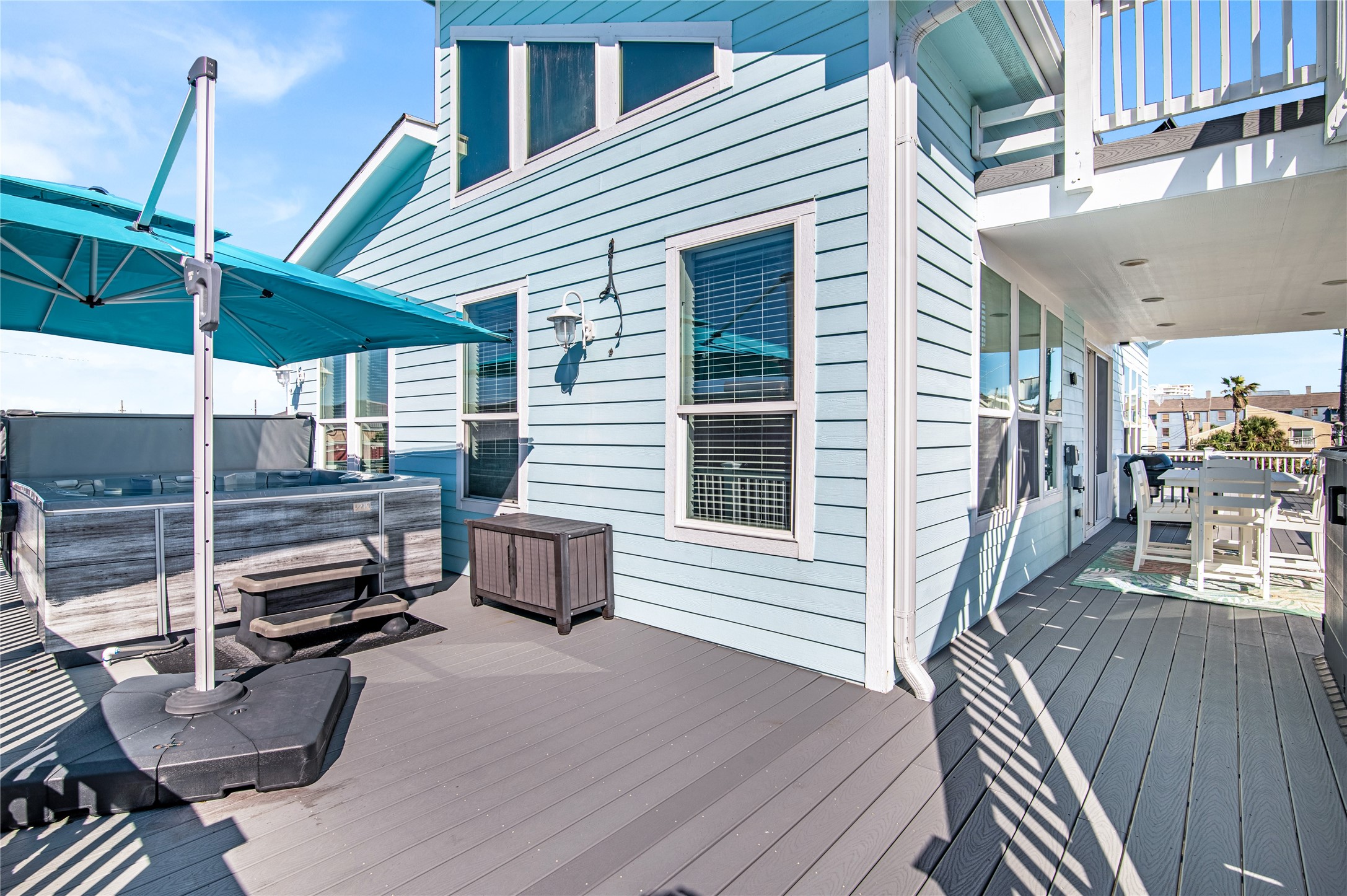 3709 Rice Street Galveston, TX 77554 - Photo 37 of 46 a view of a patio with table and chairs with wooden floor and fence