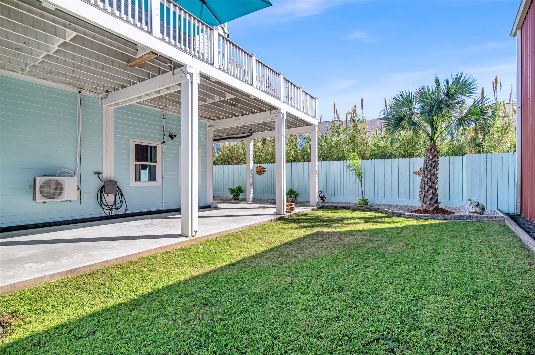 3709 Rice Street Galveston, TX 77554 - Photo 42 of 46 a view of a backyard with table and chairs and potted plants