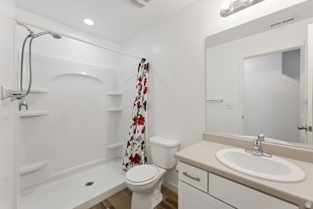 14764 Rising Star Way Riverton, UT 84065 - Photo 27 of 42 Bathroom featuring a shower stall with built-in shelving, a single vanity with an integrated sink, and wood-finish flooring