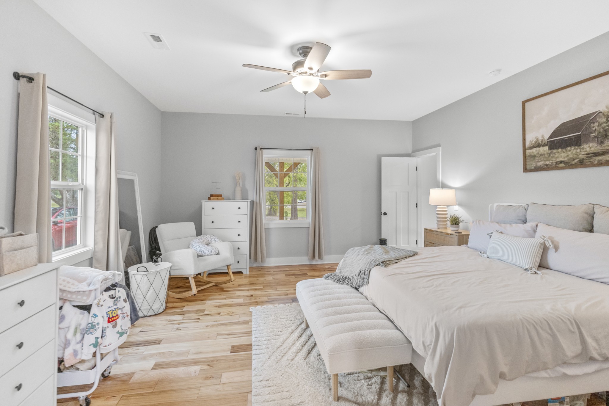 607 Old Columbia Road Unionville, TN 37180 - Photo 24 of 46 a bedroom with a large bed and a chandelier