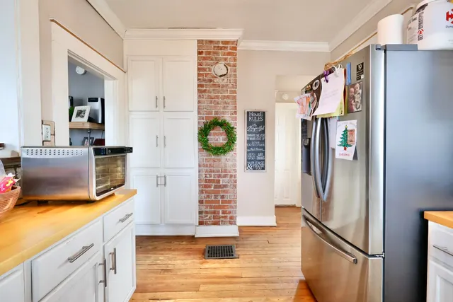 a kitchen with stainless steel appliances granite countertop a refrigerator and a stove