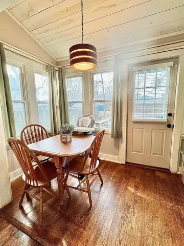 a view of a dining room with furniture wooden floor and chandelier