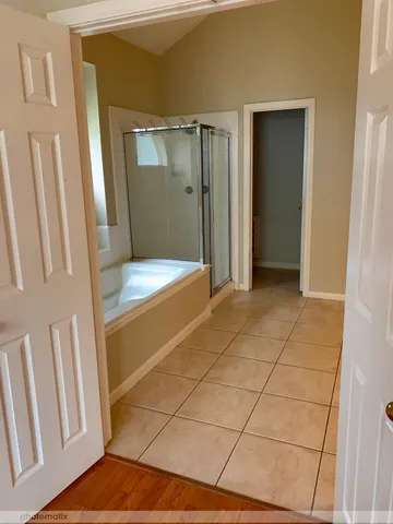 a bathroom with a shower and a sink