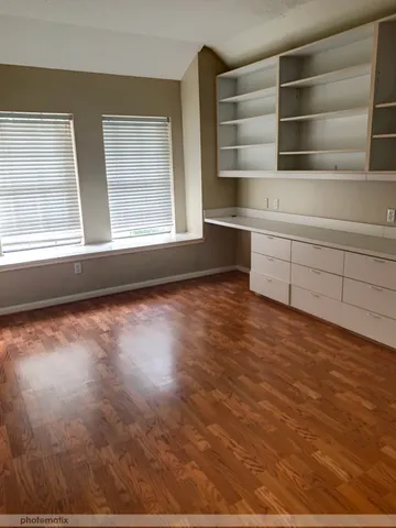 a view of a room with shelves and a window