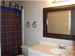a bathroom with a sink vanity mirror and toilet