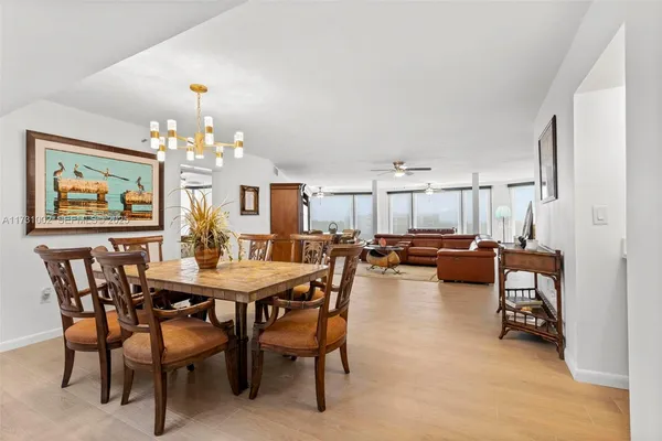 a living room with furniture ceiling fan and a window