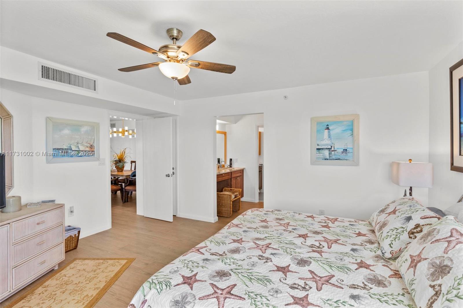 7401 Gulf Of Mexico Boulevard, Unit 4 Marathon, FL 33050 - Photo 15 of 20 a bedroom with a large bed and a chandelier
