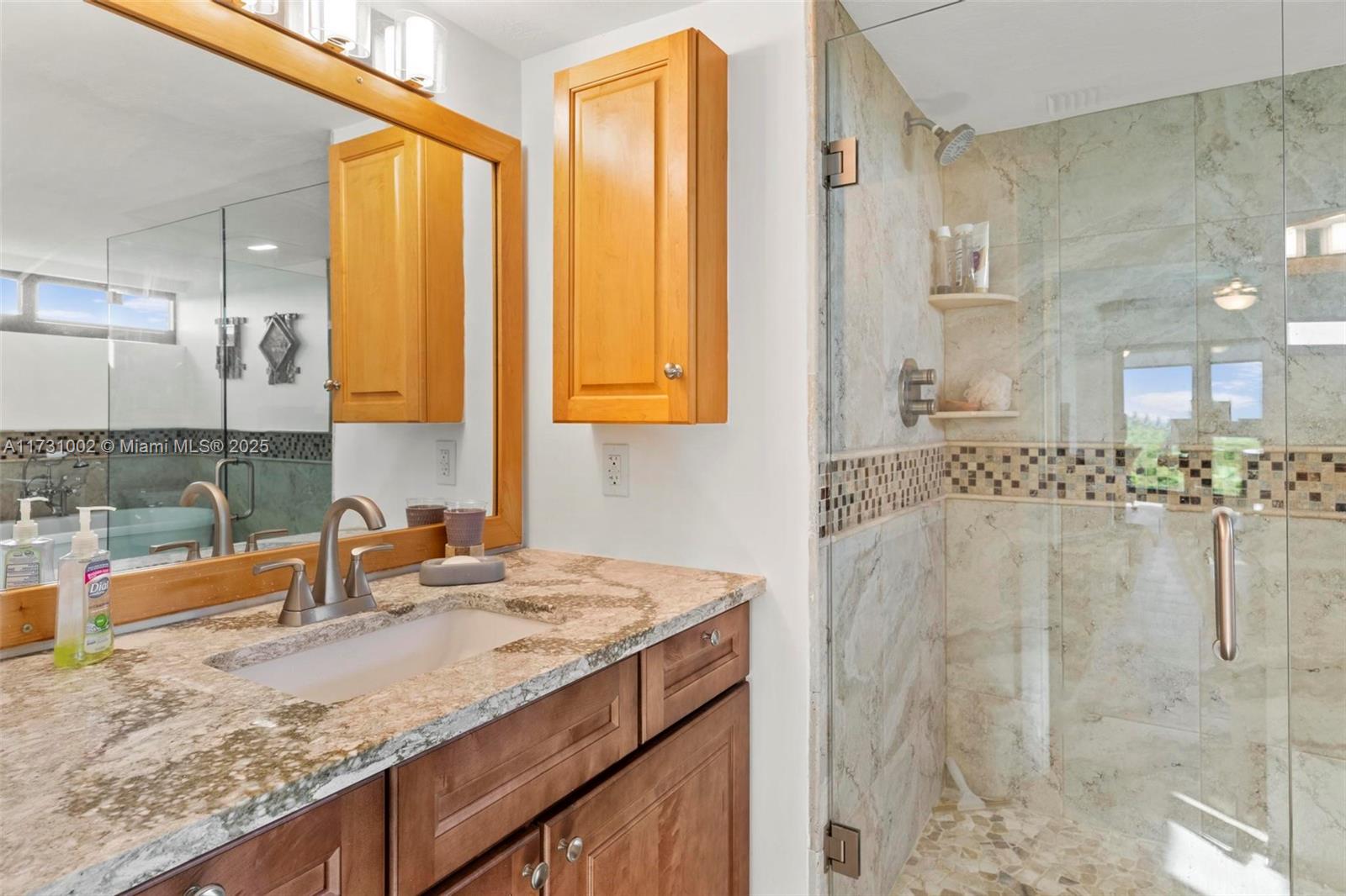 7401 Gulf Of Mexico Boulevard, Unit 4 Marathon, FL 33050 - Photo 16 of 20 a bathroom with a granite countertop sink and a mirror