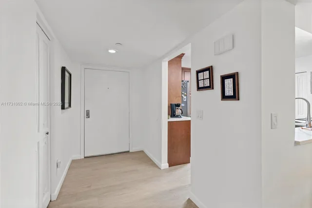 a living room with furniture ceiling fan and a large window