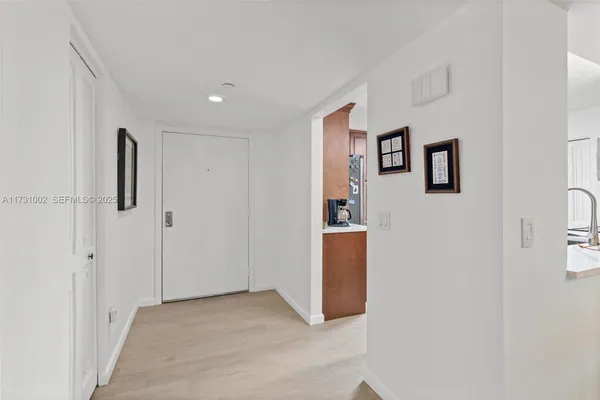 a living room with furniture ceiling fan and a large window