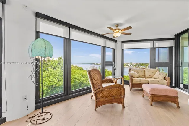 a dining room with furniture water view and a large window
