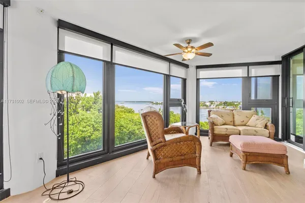 a dining room with furniture water view and a large window