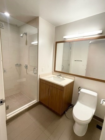 580 Washington Street, Unit 3C Boston, MA 02111 - Photo 11 of 12 a bathroom with a tub toilet and a shower