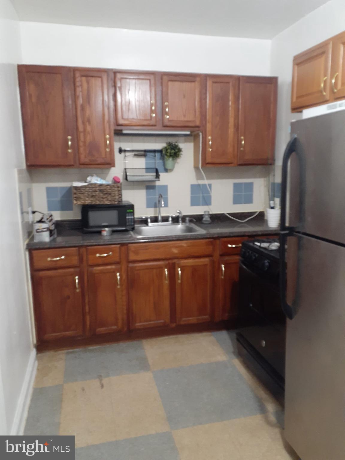 4820 New Hampshire Avenue Northwest Washington, DC 20011 - Photo 4 of 11 a kitchen with stainless steel appliances granite countertop a refrigerator and a stove top oven