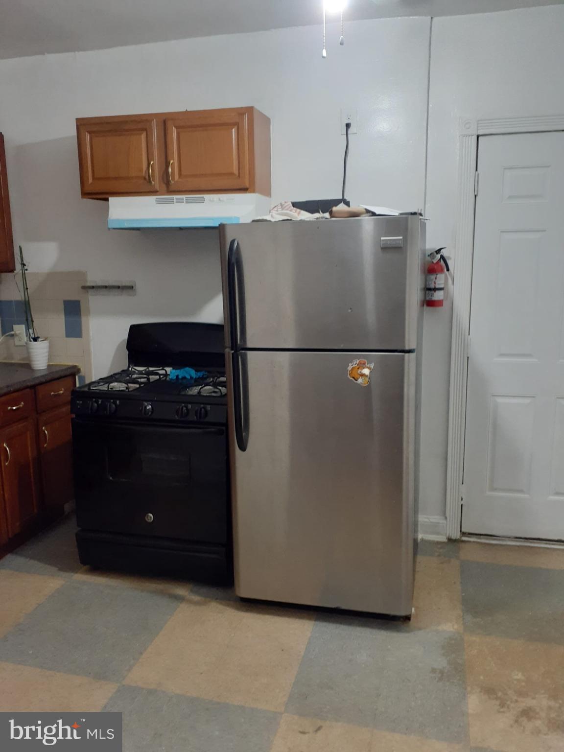 4820 New Hampshire Avenue Northwest Washington, DC 20011 - Photo 8 of 11 a white refrigerator freezer and a stove sitting inside of a kitchen