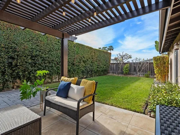 a view of a porch with furniture and garden