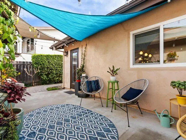 a view of a backyard with sitting area
