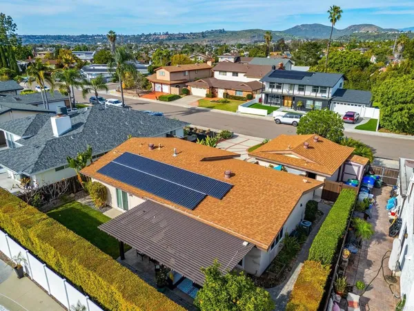 an aerial view of a house with a swimming pool yard and outdoor seating