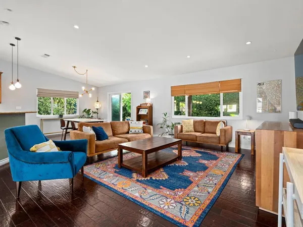 a living room with furniture rug and a large window
