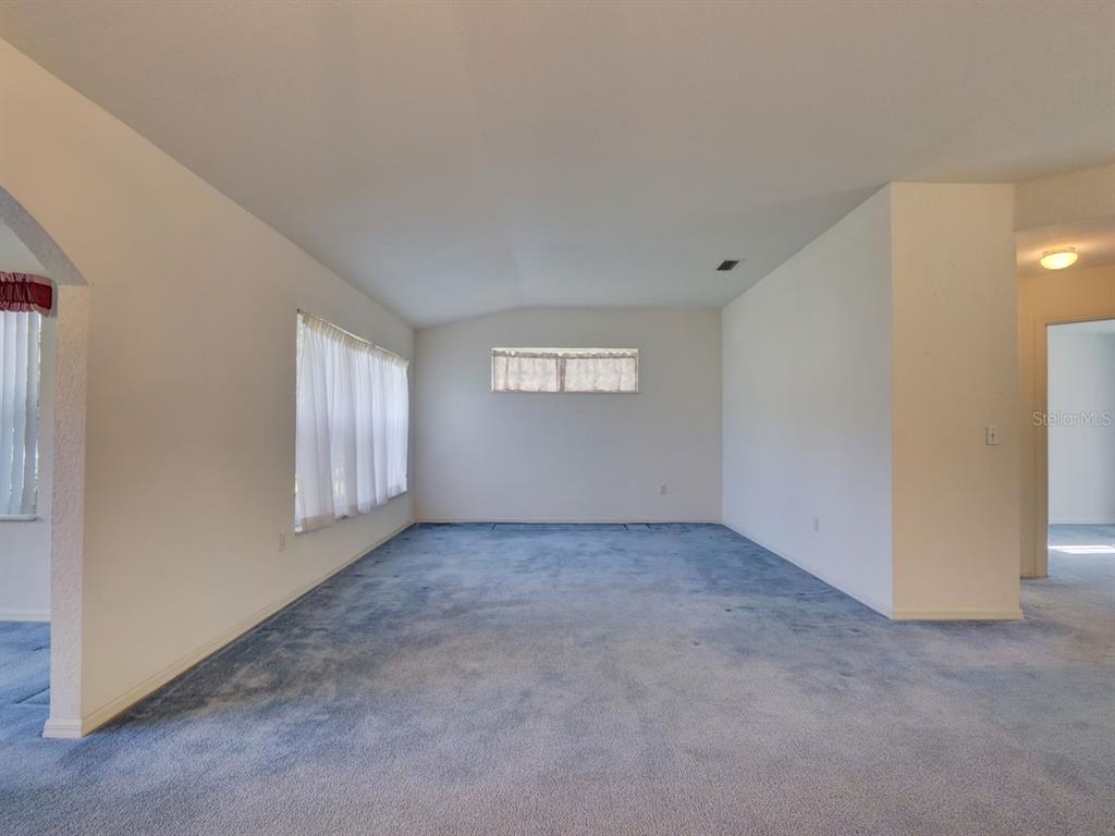 11340 Southwest 76th Circle Ocala, FL 34476 - Photo 11 of 42 a view of an empty room with windows