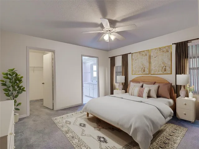 a view of an empty room with chandelier fan and fire place
