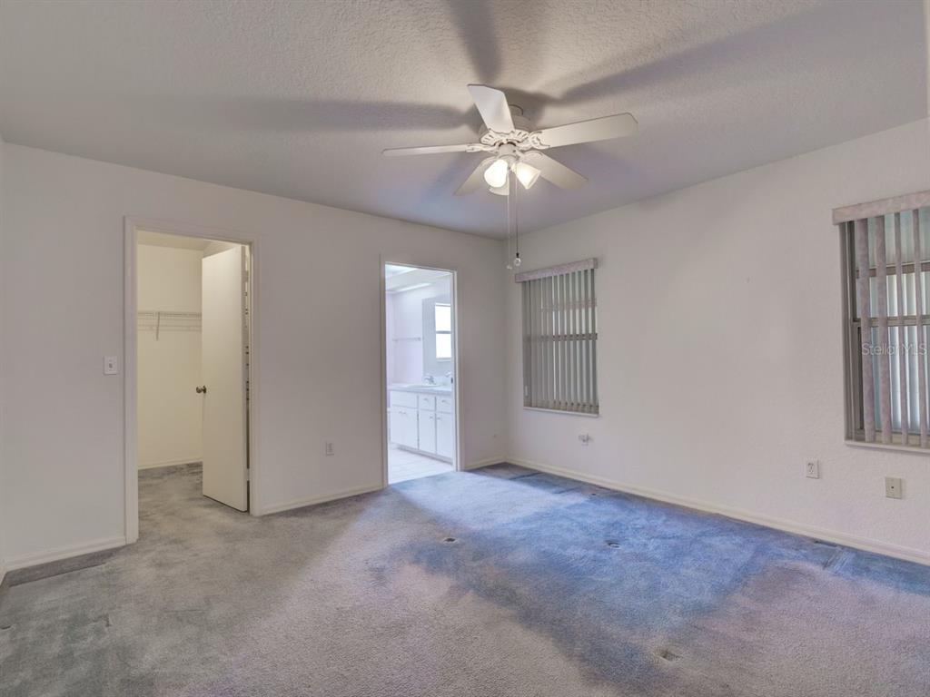 11340 Southwest 76th Circle Ocala, FL 34476 - Photo 15 of 42 a view of an empty room with chandelier fan and fire place