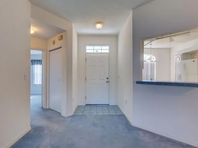 a view of a hallway with wooden floor and windows