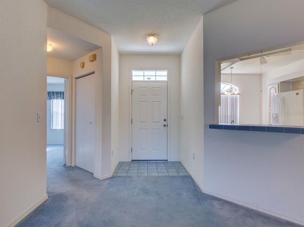 11340 Southwest 76th Circle Ocala, FL 34476 - Photo 2 of 42 a view of a hallway with wooden floor and windows