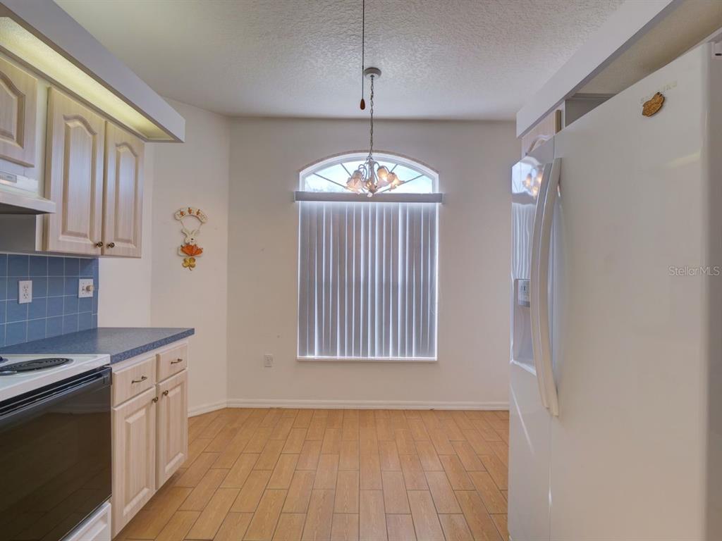 11340 Southwest 76th Circle Ocala, FL 34476 - Photo 5 of 42 a view of a kitchen with an empty space and a window
