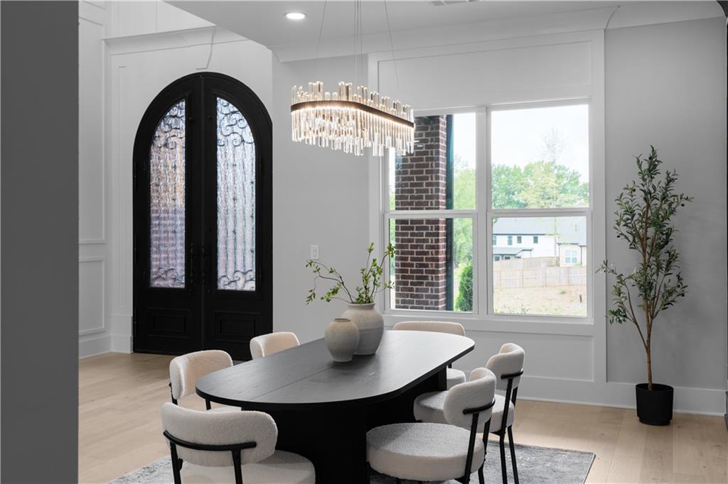 405 Thunder Road Buford, GA 30518 - Photo 14 of 104 a view of a dining room with furniture and a potted plant