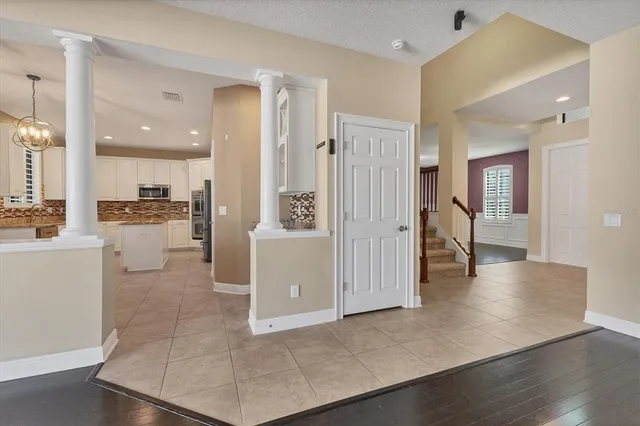 a kitchen with granite countertop a refrigerator and a sink