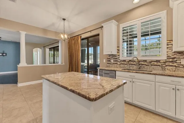 a kitchen with stainless steel appliances granite countertop a refrigerator a sink dishwasher and a stove top oven