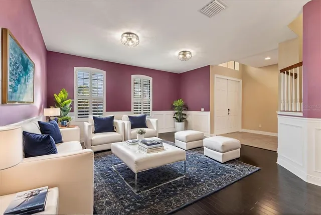 a view of a a dining room with furniture window and wooden floor