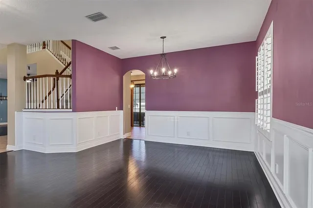a view of an empty room with a ceiling fan