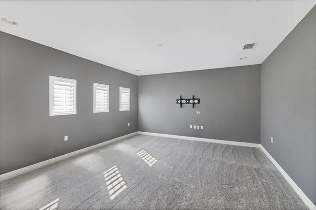 an aerial view of a houses with a swimming pool