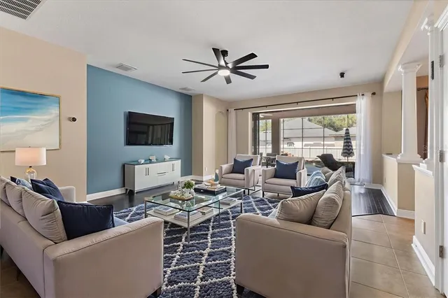 a view of a livingroom with wooden floor and a ceiling fan